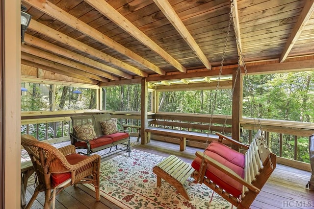 sunroom featuring lofted ceiling with beams and wooden ceiling