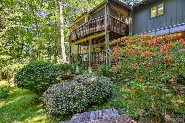 rear view of property featuring a deck