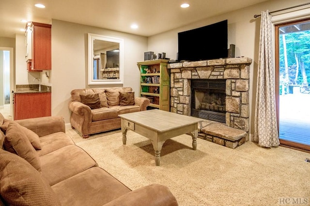 living room with light colored carpet and a fireplace