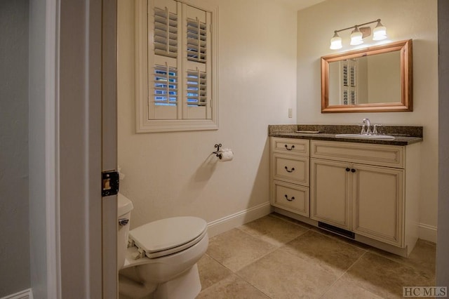 bathroom featuring vanity, tile patterned floors, and toilet