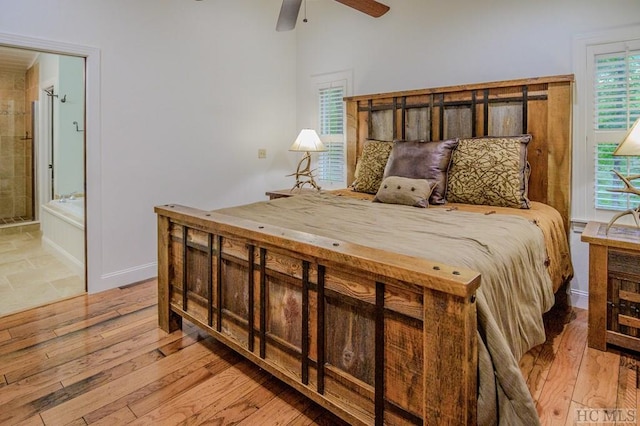 bedroom featuring ceiling fan, ensuite bath, and light hardwood / wood-style floors