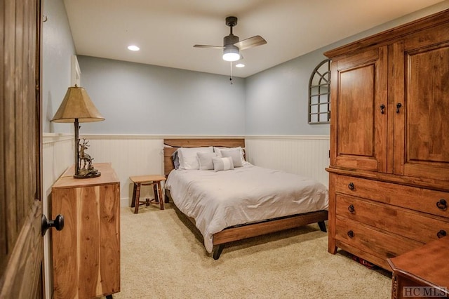 bedroom featuring light carpet and ceiling fan