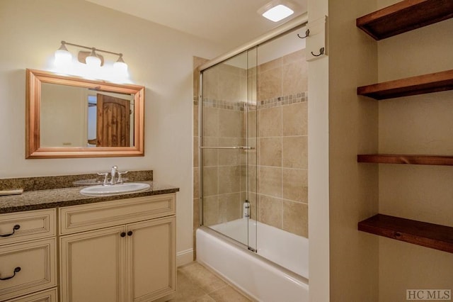 bathroom featuring tile patterned floors, bath / shower combo with glass door, and vanity