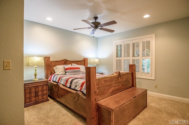 bedroom with ceiling fan and light carpet