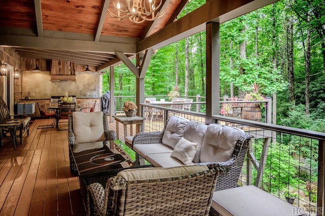 deck featuring an outdoor living space and a grill