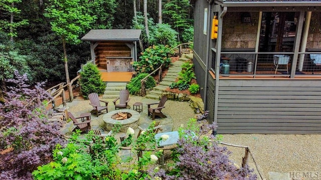 view of yard featuring a patio and an outdoor fire pit