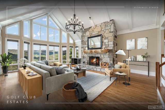 living area featuring a chandelier, high vaulted ceiling, a fireplace, wood finished floors, and beamed ceiling