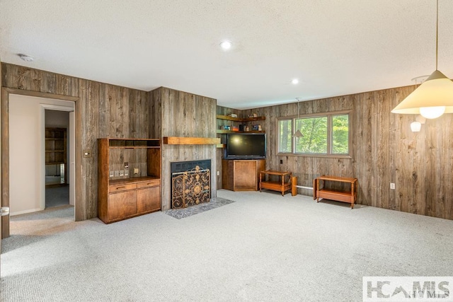 living room with carpet flooring and wood walls