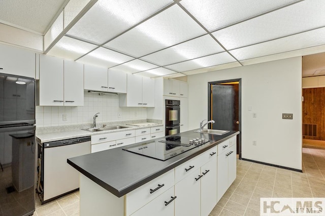 kitchen featuring black appliances, white cabinetry, visible vents, and a sink