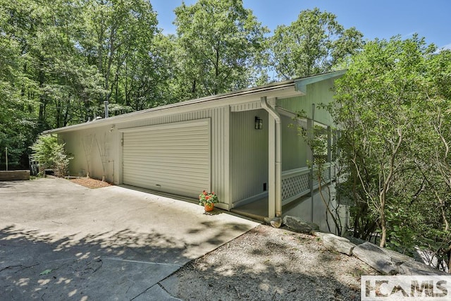 garage with concrete driveway