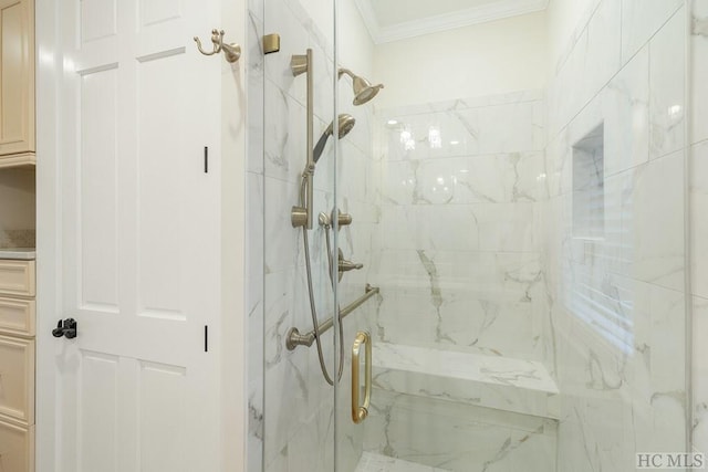 bathroom featuring a shower with door and ornamental molding