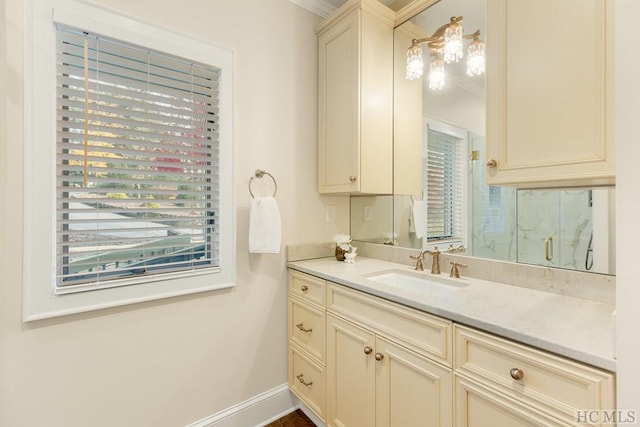 bathroom with vanity, crown molding, and a shower with door