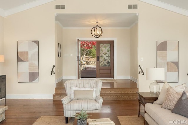 interior space featuring crown molding, wood-type flooring, and a notable chandelier