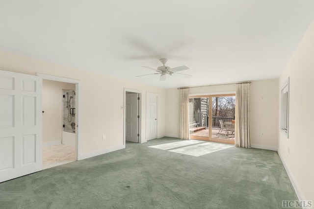 empty room featuring ceiling fan and light colored carpet