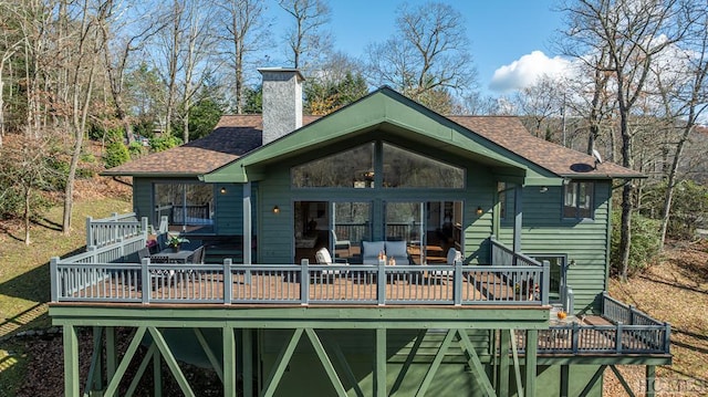 rear view of house featuring a wooden deck