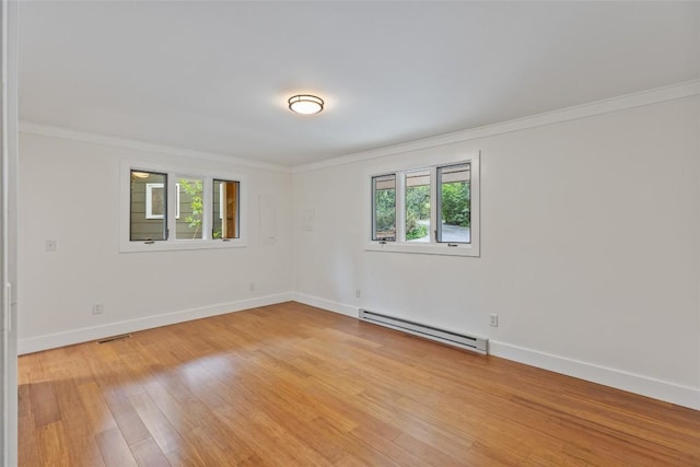 66 Hemlock Ln, Highlands, NC 28741 - empty room featuring a baseboard heating unit, crown molding, light wood-type flooring, and baseboards