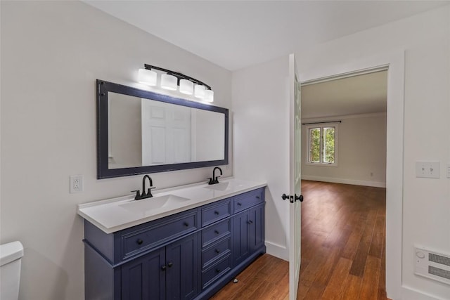 66 Hemlock Ln, Highlands, NC 28741 - bathroom featuring wood finished floors, double vanity, toilet, and baseboards