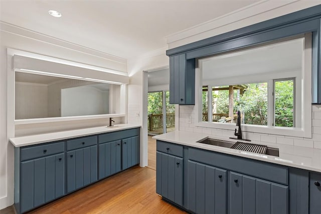 66 Hemlock Ln, Highlands, NC 28741 - kitchen with tasteful backsplash, a sink, light countertops, and light wood-style flooring
