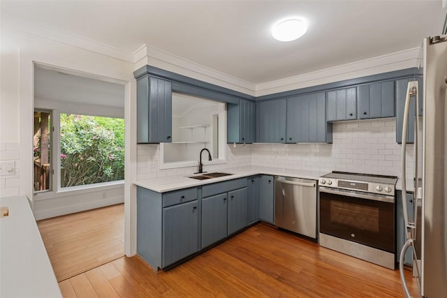 66 Hemlock Ln, Highlands, NC 28741 - kitchen featuring stainless steel appliances, a sink, light countertops, tasteful backsplash, and light wood finished floors