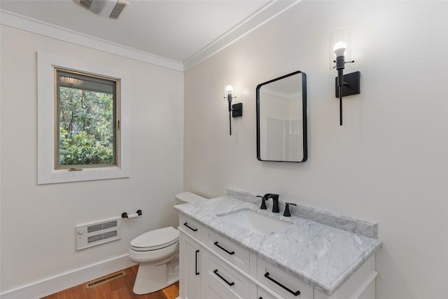 66 Hemlock Ln, Highlands, NC 28741 - bathroom with heating unit, vanity, wood finished floors, toilet, and ornamental molding