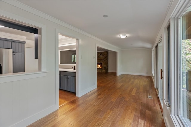 66 Hemlock Ln, Highlands, NC 28741 - hallway featuring light wood-style flooring, crown molding, baseboards, and a sink