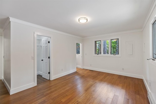 66 Hemlock Ln, Highlands, NC 28741 - unfurnished bedroom with wood finished floors, baseboards, ornamental molding, a spacious closet, and a closet