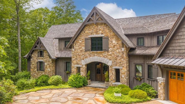 39 Firesong Ln, Glenville, NC 28736 - view of front of property featuring stone siding, a standing seam roof, and a metal roof