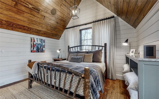 39 Firesong Ln, Glenville, NC 28736 - bedroom featuring vaulted ceiling, wooden ceiling, wood finished floors, and wooden walls