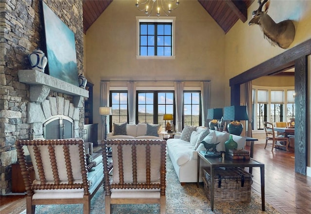 39 Firesong Ln, Glenville, NC 28736 - living room featuring high vaulted ceiling, wood ceiling, plenty of natural light, a chandelier, and a stone fireplace