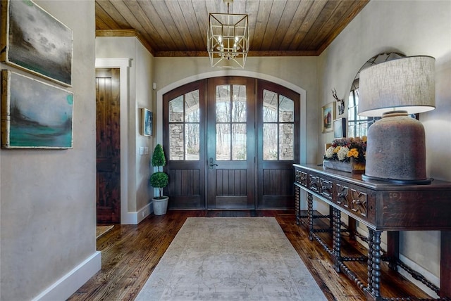 39 Firesong Ln, Glenville, NC 28736 - foyer entrance with arched walkways, a chandelier, ornamental molding, dark wood finished floors, and wooden ceiling