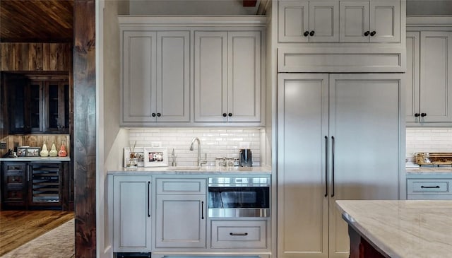 39 Firesong Ln, Glenville, NC 28736 - kitchen featuring beverage cooler, decorative backsplash, light stone counters, wall oven, and paneled built in fridge