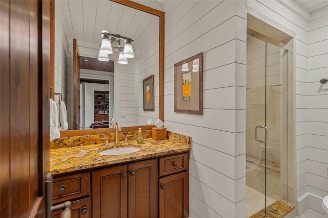 39 Firesong Ln, Glenville, NC 28736 - bathroom featuring a stall shower, vanity, and wooden walls