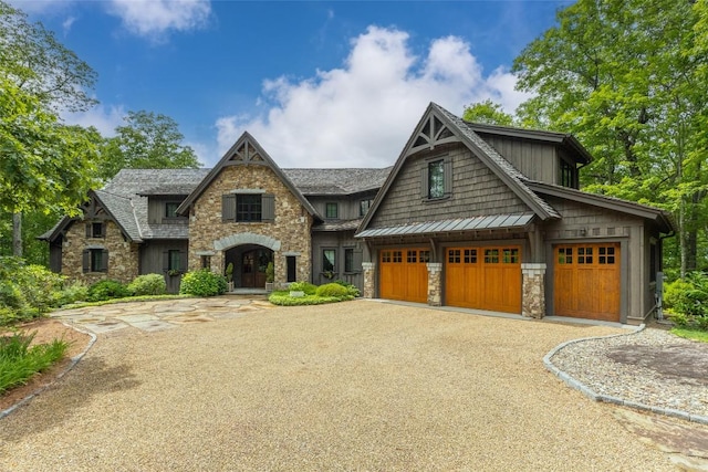 39 Firesong Ln, Glenville, NC 28736 - view of front of house with stone siding, gravel driveway, a standing seam roof, and a metal roof
