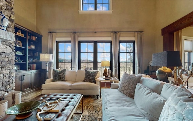 39 Firesong Ln, Glenville, NC 28736 - living room featuring a towering ceiling, a fireplace, and wood finished floors