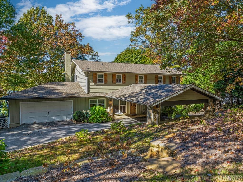 view of front of house with a garage and a carport