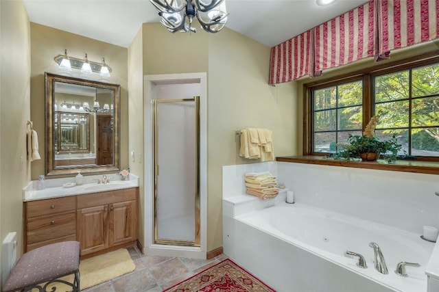 bathroom with vanity, a bath, a stall shower, and a chandelier