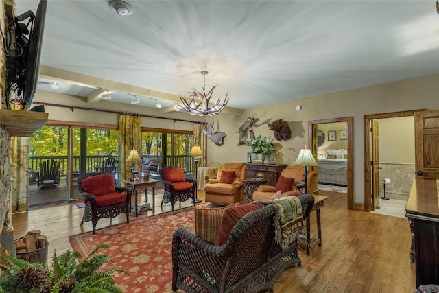 living room with light wood-style floors and a notable chandelier
