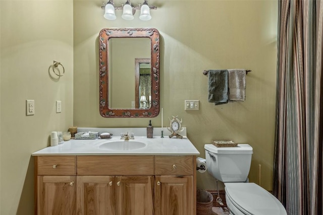 bathroom featuring vanity and toilet