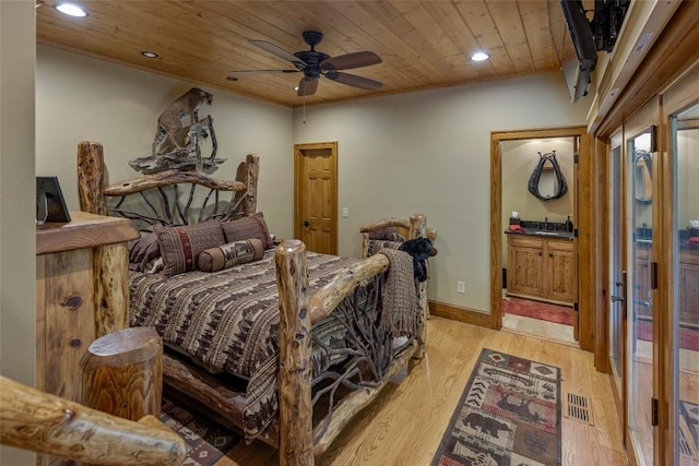 bedroom featuring visible vents, recessed lighting, wood ceiling, a sink, and light wood-style flooring