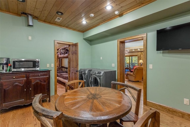 dining area with washer and dryer, visible vents, wooden ceiling, and light wood-type flooring