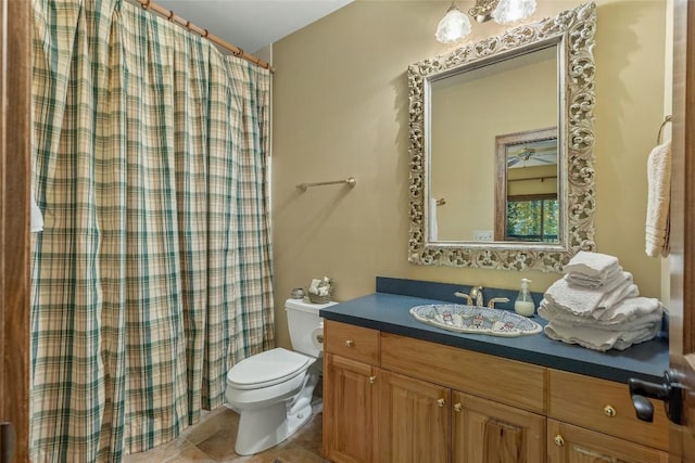 bathroom with toilet, tile patterned floors, a shower with curtain, and vanity