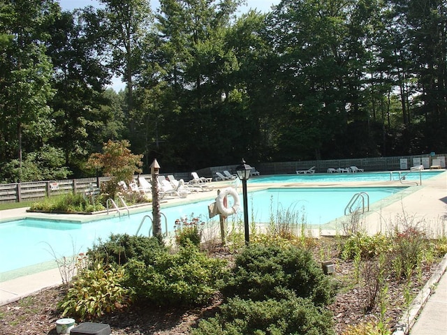 735 Trays Island Rd, Sapphire, NC 28774 - community pool featuring a patio area and view of wooded area