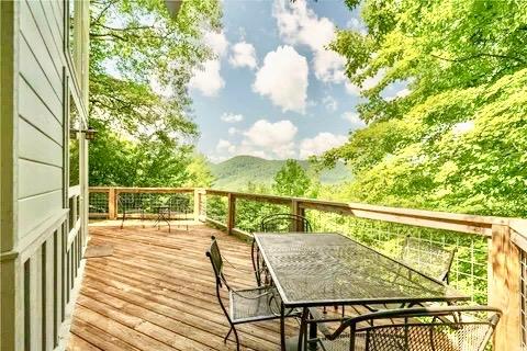 735 Trays Island Rd, Sapphire, NC 28774 - wooden terrace with outdoor dining space and a mountain view