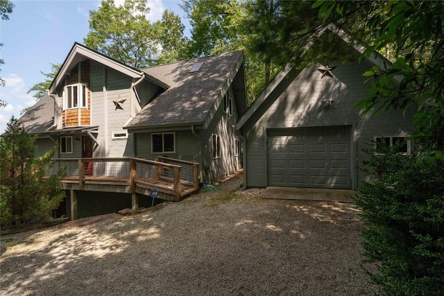 735 Trays Island Rd, Sapphire, NC 28774 - rear view of house with driveway, a deck, and a garage