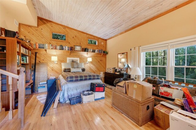 bedroom featuring wood ceiling, wood finished floors, high vaulted ceiling, wooden walls, and ornamental molding