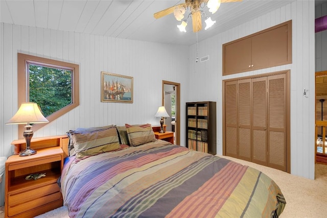 bedroom with a closet, a ceiling fan, carpet, and visible vents