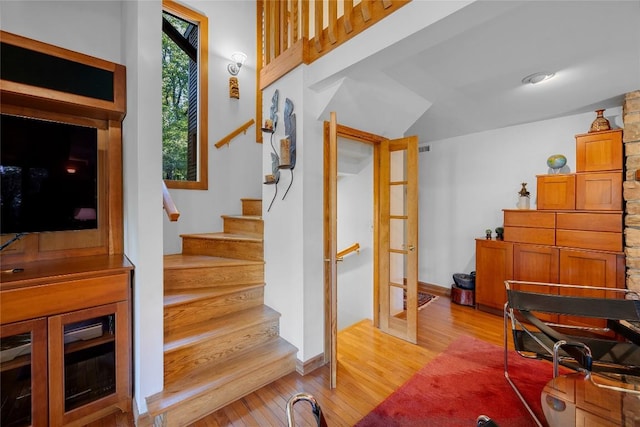 stairs featuring wood finished floors