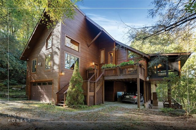 view of home's exterior with stairs, an attached garage, and driveway
