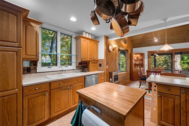 kitchen with a sink, a wealth of natural light, butcher block counters, and dishwasher