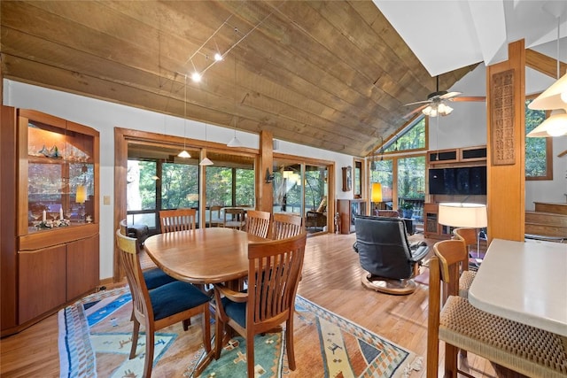 dining room with high vaulted ceiling, a ceiling fan, and wood finished floors